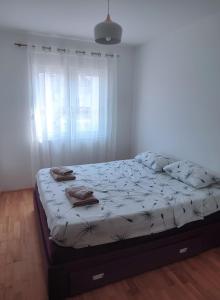 a bedroom with a bed with towels on it at A l e k a in Radovići