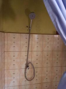 a shower in the corner of a bathroom at NIGHT ROCKS SUITS in Jinja