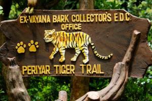 a sign with a tiger walking on it at New Heaven Group accommodation in Thekkady