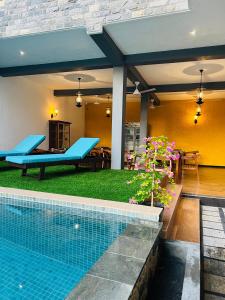 a house with a swimming pool and a patio at Mama’s Boutique Beach Hotel in Negombo