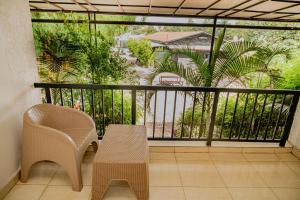 a balcony with a table and chairs and a view at Boutique Hotel Rwanda in Kigali