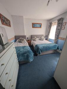 a bedroom with two beds and a window at Hesketh Hotel in Blackpool