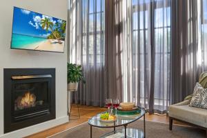a living room with a fireplace and a tv at Apartment Geelong Heritage Luxury Ground Floor Courtyard in Geelong