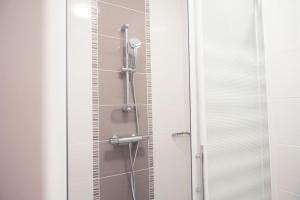 a shower with a glass door in a bathroom at L'Etape - La Maison des amis in Tours +21 photos