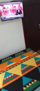 a colorful rug on the floor in a room at Airport MD rooms 2 in Belgrade
