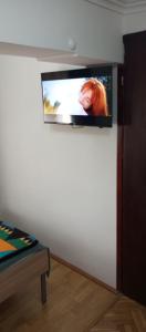 a flat screen tv on a wall in a room at Airport MD rooms 2 in Belgrade