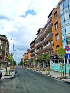 an empty street in a city with tall buildings at Smile in Burgas