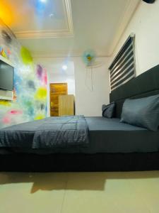 a bedroom with a bed and a television in it at Port Punta in Lekki