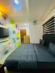 a bedroom with a bed and a flat screen tv at Port Punta in Lekki