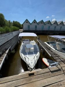a boat is docked at a dock in the water at Haus am See in Neusiedl am See