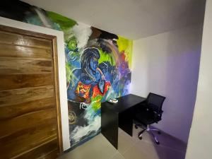 a painting on the wall of a room with a desk at Port punta in Lekki