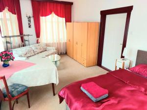 a living room with a bed and a couch at Gasthof Oberschmiede in Auf der Wiese