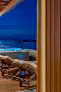 a room with a table and chairs on a ship at Lalari Beach Suites in Vari