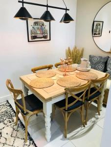 a dining room with a wooden table and chairs at Newly Renovated 5 Star Cosy-Up Romantic Cottage NEAR LONGLEAT in Warminster