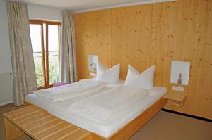 a bedroom with a large white bed with a window at Hotel Geisler Tulfes in Tulfes +62 photos