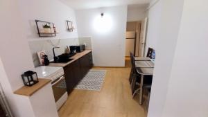 a kitchen with a sink and a counter top at CLASSY 2-Dormitoare in Baia Mare