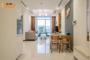 een keuken en een woonkamer met een tafel en stoelen bij Vinhomes CenTral Park Saigon in Ho Chi Minh-stad