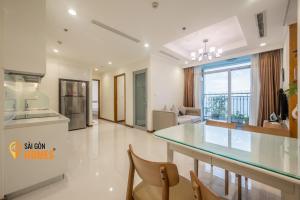 eine Küche und ein Wohnzimmer mit einer Glasscheibe in der Unterkunft Vinhomes CenTral Park Saigon in Ho-Chi-Minh-Stadt