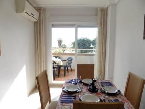 a dining room with a table and chairs and a window at Playa Ribera MED002 in La Estación