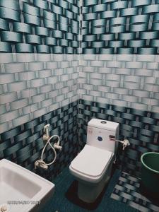 a bathroom with a toilet and a sink at Anaya Guest House Etah in Etah