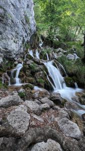 a stream of water flowing down a rocky hillside at B&B Fiume in Morino
