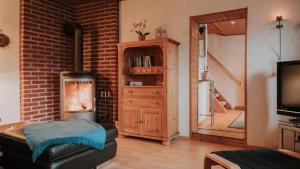 a living room with a fireplace and a brick wall at Hexenhütte in Sankt Andreasberg
