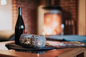 a table with two cups and a bottle of wine at Hexenhütte in Sankt Andreasberg +16 photos