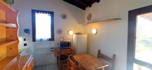 a kitchen with a wooden table and a refrigerator at Home 55 in Porto Istana
