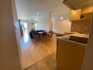 a kitchen and living room with a table and chairs at apartmán Maják u Žermanické přehrady in Pitrov