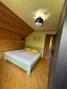 a small bedroom with a bed in a attic at Cottage Zelman in Yaremche