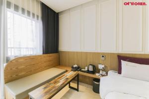 a hotel room with a bed and a desk in it at Chungjangro Ilbeonji Boutique Hotel in Gwangju