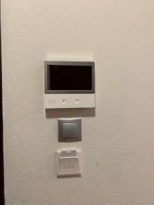 a computer monitor on a wall with a box at Cozy Corner - Apartment in Korça in Korçë