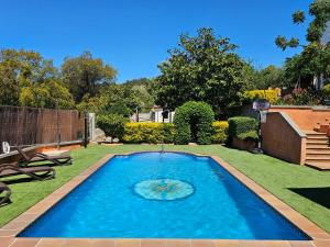 a swimming pool in the middle of a yard at VILLA ARBUCIES with private pool in Lloret de Mar