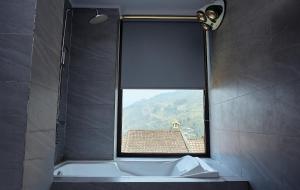 a bathroom with a tub and a window with a view at An's House SaPa - Nguyên Căn 5 Phòng Ngủ View Núi in Sapa +39 photos