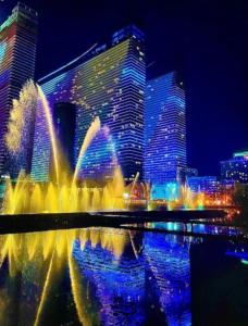 a water fountain in front of a city at night at ORBI CITY lux studio apartment in Batumi
