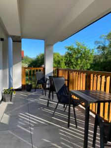 a patio with chairs and a table on a deck at Willa Torfowa in Wisła