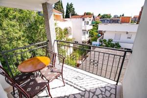 a balcony with a table and chairs on a balcony at Vila Vojka in Bar +3 photos