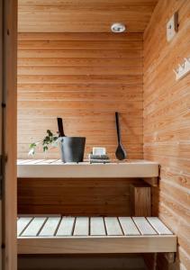 a sauna with wooden walls and a wooden bench at Bright apartment, airport 3km, private parking, sauna in Vantaa