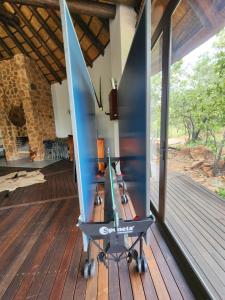 a boat sitting on top of a wooden deck at Milkwood Safari Lodge in Warmbaths