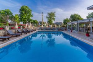 a swimming pool with blue water in a house at HOTEL DALYANCE in Dalyan