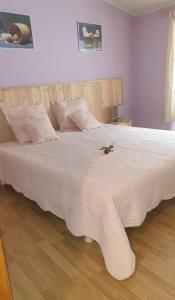 a bedroom with a large bed with a white bedspread at Oustals De Lavail in Ascou