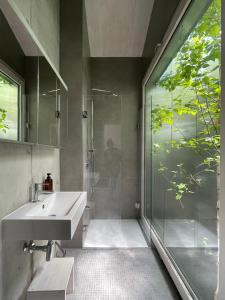 a bathroom with a sink and a glass shower at Chalet contemporain in Gryon