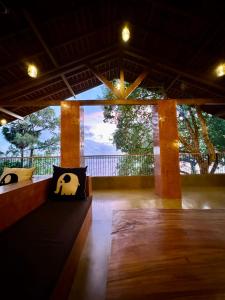 a room with two pillows and a large window at Art Yala in Tissamaharama