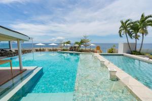 a swimming pool with the ocean in the background at Serene Oasis Resort - Oslob Cebu Philippines in Oslob