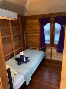 a room with a bunk bed with a hat on it at Gili Davidoff Upstairs Budget And Deluxe in Gili Trawangan