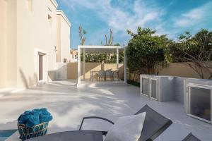 a patio with a table and chairs on a patio at Luxurious Villa, Private Pool and Garden, Dubai in Dubai