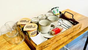 a wooden tray with cups and dishes on a table at Swallow Barn in Penrith