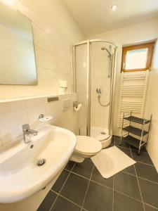 a bathroom with a sink and a toilet and a shower at Modern Mountain Apart 5 - an der Skipiste in Rauris