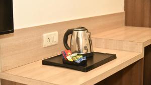 a tea kettle on a tray on a counter at Hotel MM Continental in Varanasi