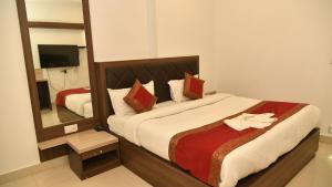 sypialnia z dużym łóżkiem z dużym lustrem w obiekcie Hotel MM Continental w mieście Waranasi